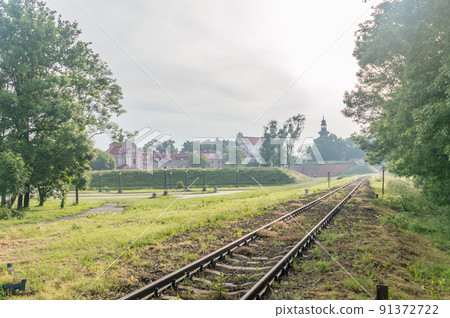 Railway track with old old town of Zamosc in background. Railway track with old old town of Zamosc in background. 91372722