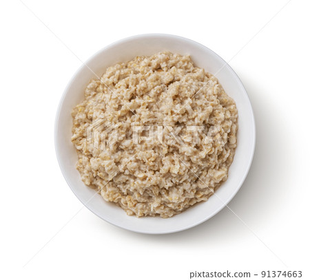 Bowl of oatmeal isolated on white background, top view 91374663