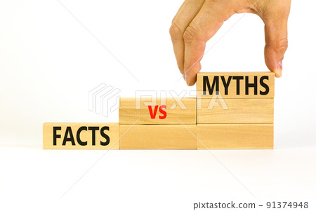 Facts vs myths symbol. Concept words Facts vs myths on wooden blocks on a beautiful white table white background. Businessman hand. Business, finacial and facts vs myths concept. Copy space. 91374948