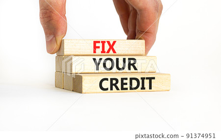 Fix your credit symbol. Concept words Fix your credit on wooden blocks on a beautiful white table white background. Businessman hand. Business, finacial and fix your credit concept. Copy space. 91374951