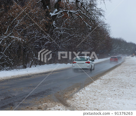 driving in winter after a snowfall, ice on the road, temperatures below zero driving in winter after a snowfall, ice on the road, temperatures below zero 91376263