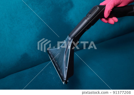Dirty sofa chemical cleaning with professionally extraction method. Upholstered furniture. Early spring cleaning or regular clean up. Dirty sofa chemical cleaning with professionally extraction method. Upholstered furniture. Early spring cleaning or regular clean up. 91377208