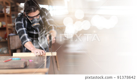 Carpenter working on woodworking machines in carpentry shop. he works in a carpentry shop or warehouse 91378642