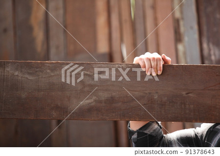 Carpenter working on woodworking machines in carpentry shop. he works in a carpentry shop or warehouse 91378643
