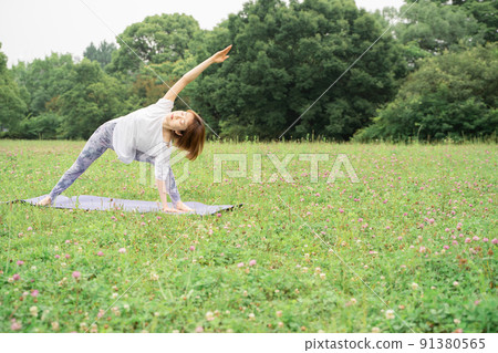 Park yoga pose to stretch the body side 91380565