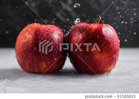 Red-yellow apples with drops close-up on a white plate. Fruit on a plate. Red-yellow apples with drops close-up on a white plate. Fruit on a plate. 91380835