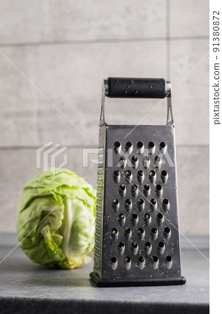 Nearby is grater and cabbage. 91380872