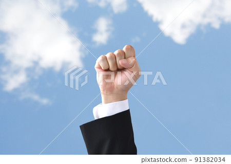 The hand of a businessman pushed up by the blue sky The hand of a businessman pushed up by the blue sky 91382034