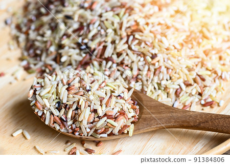 brown rice on wooden spoon , raw various rice color mixed thai rice for cooking food , Loonzain rice brown black red white purple health food. brown rice on wooden spoon , raw various rice color mixed thai rice for cooking food , Loonzain rice brown black red white purple health food. 91384806