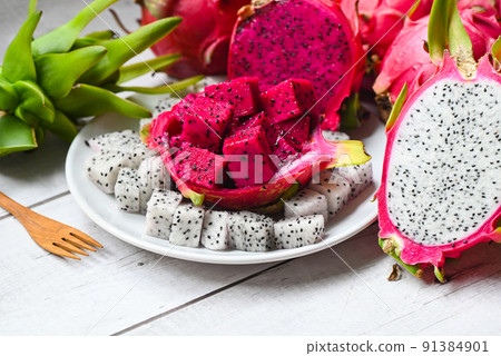 dragon fruit slice and cut half on white plate with pitahaya background , fresh white and red purple dragon fruit tropical in the asian thailand healthy fruit concept 91384901