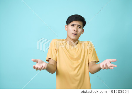 Young men poses suspiciously in the studio concept. 91385964