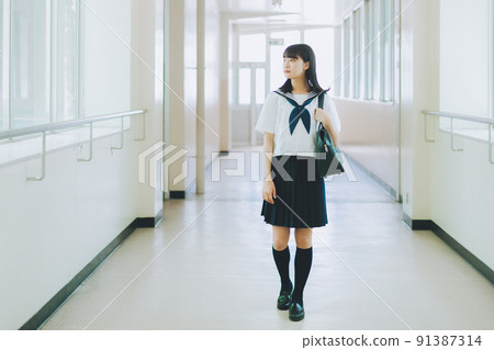 High school student walking in the school corridor 91387314