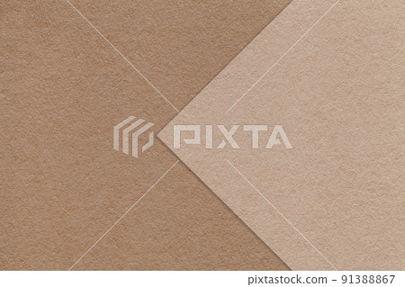 Texture of brown and beige paper background, half two colors with arrow, macro. Structure of dense craft cardboard. 91388867