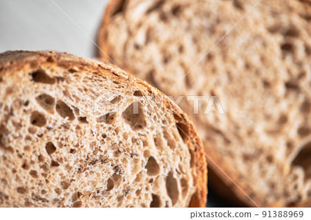 The process of making wheat bread at home. A slice of homemade sourdough bread. The concept of healthy homemade food. Front view. 91388969