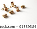 Plumbing faucet and brass fittings on the white background repairing or replacing different equipment 91389384