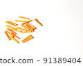 Plastic orange dowels on the white background. Construction and building background. 91389404