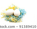 Minimal easter concept. Easter eggs in a colorful basket on a white background. Copy space for text. 91389410