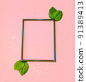 Summer modern composition. Black frame, green leaves on pastel pink background. Flat lay, top view, copy space 91389413