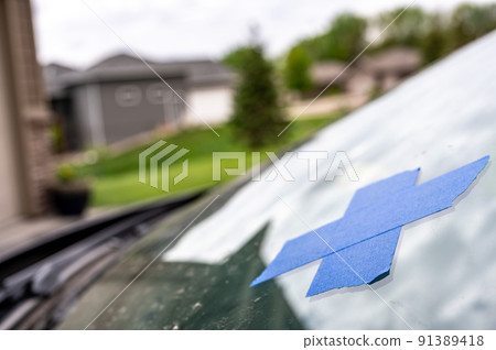 Tape covering a chip on a car windshield. Tape covering a chip on a car windshield. 91389418