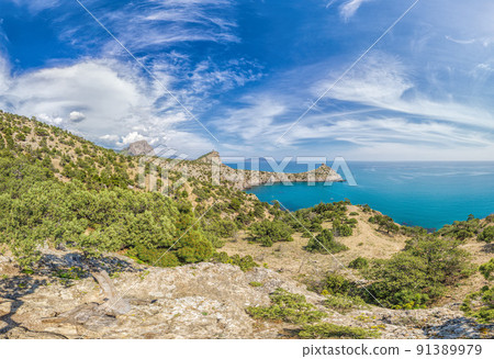 Beautiful seascape, panorama of cape Kapchik to the Galitsin Trail and blue bay of the Black Sea. Sudak, New World. Landscape of the sea coast. The concept of calmness, silence and unity with nature. Beautiful seascape, panorama of cape Kapchik to the Galitsin Trail and blue bay of the Black Sea. Sudak, New World. Landscape of the sea coast. The concept of calmness, silence and unity with nature. 91389979