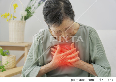 Elderly woman feeling chest pain at home 91390575