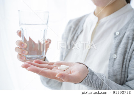 A woman drinking supplements 91390758