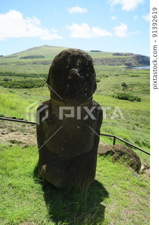 A sitting moai statue in Rano Raraku on Easter Island A sitting moai statue in Rano Raraku on Easter Island 91392619