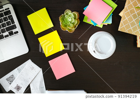 Office desk with stationery items and laptop 91394219