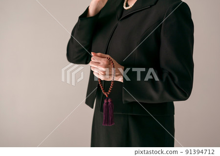 A woman wiping her tears with a handkerchief 91394712