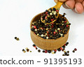 Chef taking dry spices mixture of different colored peppers peas from wooden spice jar. 91395193