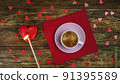 Cup of coffee on red napkin and set fire heart-shaped candle with long match. A romantic day. Valentines day or womens day concept. Top view. Flat lay. Close-up. 91395589