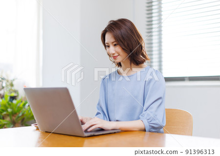 A woman working from home A woman working from home 91396313