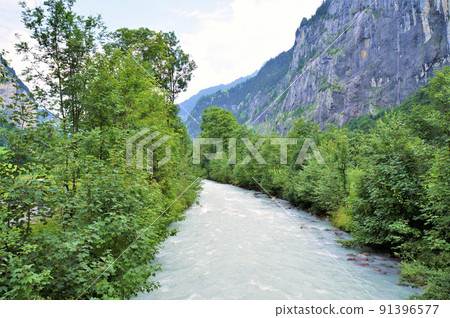 A stream flowing through the valley of Lauterbrunnen [Switzerland] 91396577