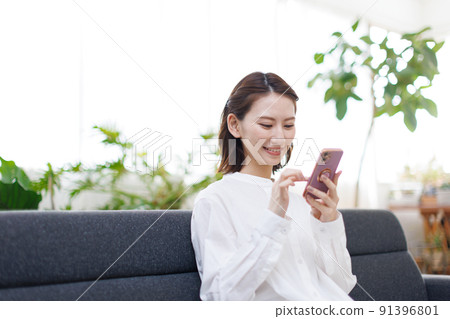 A woman watching a smartphone 91396801