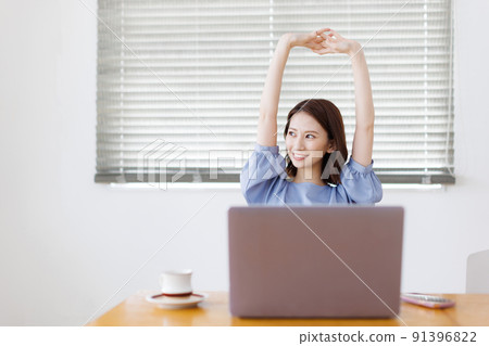 A woman taking a break at home work A woman taking a break at home work 91396822