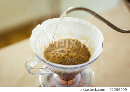 Close-up of a v60 decanter, alternative method of brewing coffee. Air bubbles on the coffee bed. 91396909