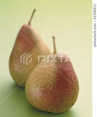 two pears on a green background 91396911
