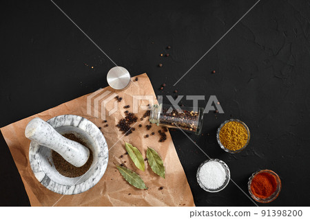 Various spices and mortar on black background with copy space 91398200