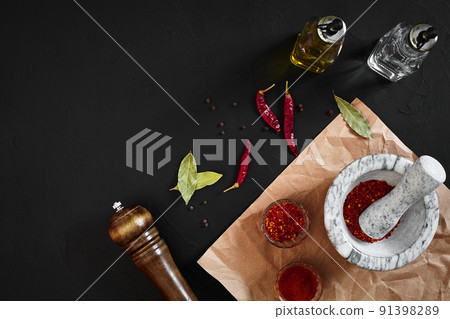 Dried and crushed red chili pepper in stone mortar. Copy space Dried and crushed red chili pepper in stone mortar. Copy space 91398289