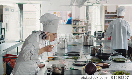 Woman working as cook testing bad soup for gourmet dish, making mistake in preparing culinary recipe. Authentic chef doing taste test with sauce, cooking in professional gastronomy kitchen. Woman working as cook testing bad soup for gourmet dish, making mistake in preparing culinary recipe. Authentic chef doing taste test with sauce, cooking in professional gastronomy kitchen. 91398297