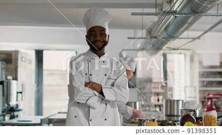 Portrait of male chef with arms crossed working in restaurant kitchen, cooking professional cuisine dish. Authentic cook making food preparations to do culinary gourmet meal, feeling confident. 91398351