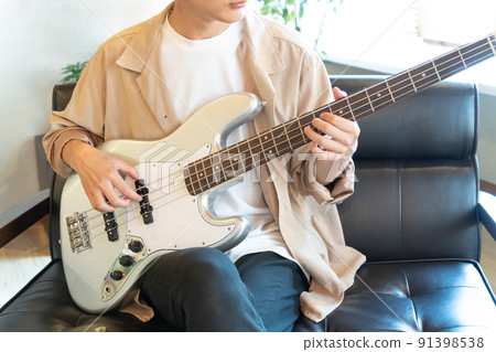 Young man playing electric bass Young man playing electric bass 91398538