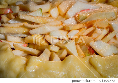 Uncooked galette, open pie with apples in electric oven: close up 91399278