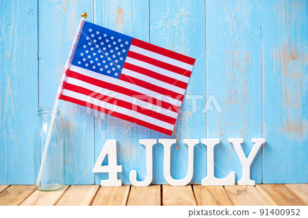 Fourth of July text and United States of America flag on wooden table background. USA holiday of Independence and celebration concepts 91400952
