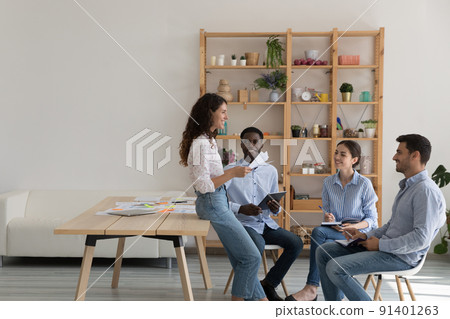 Team of ambitious corporate staff communicate in office during briefing 91401263