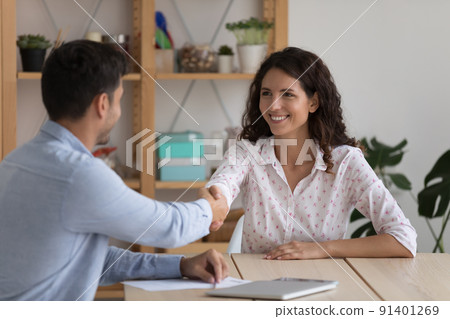 Client and sales manages handshaking after closing deal in office Client and sales manages handshaking after closing deal in office 91401269