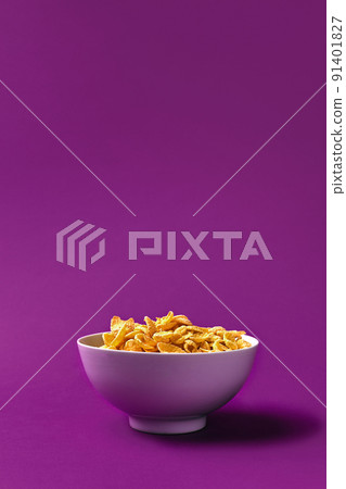 Bowl with cornflakes on the colorful background 91401827