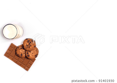 Glass of milk and cookies on white background with space for text or design. Top view Glass of milk and cookies on white background with space for text or design. Top view 91401930