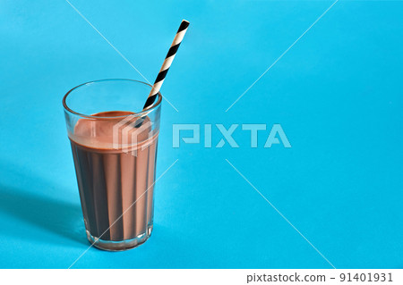 Chocolate milk on blue background with space for text or design 91401931