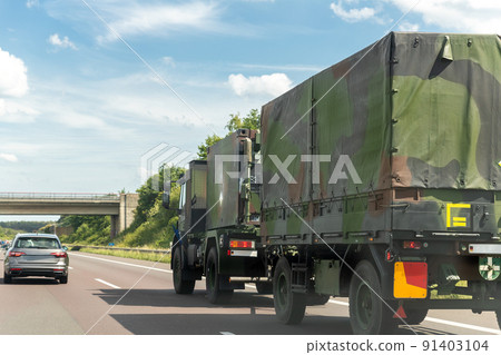 German armoured semi-trailer cargo truck carrier drives military convoy highway road. NATO troops moving reloceation rapid reaction force reinforcement eastern Europe . Sweden Finland fortification German armoured semi-trailer cargo truck carrier drives military convoy highway road. NATO troops moving reloceation rapid reaction force reinforcement eastern Europe . Sweden Finland fortification 91403104